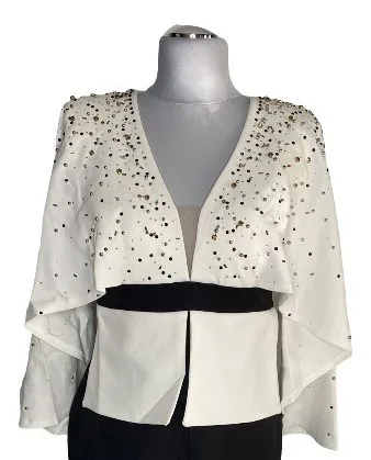 A mannequin displays the Beaded Cape Front Slit Long Dress, a white long-sleeved open-front shrug with gold sequins, layered over a black bodycon dress for a chic monochrome look.