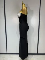A gold mannequin, seen in profile against a light background, models the Crystal Bust Long Bodycon Dress—a strapless black gown featuring a white crystal-studded bust.