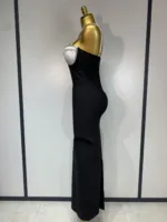 A gold mannequin, seen in profile against a light background, models the Crystal Bust Long Bodycon Dress—a strapless black gown featuring a white crystal-studded bust.