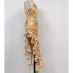 The Hollowed-Out Hip Irregular Ruffled Floral Dress features a yellow floral satin design, spaghetti straps, a fitted bodice, and a cascading ruffled high-low hem, shown on a mannequin against a plain white background.