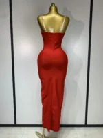 A gold mannequin displays the Crystal Bust Long Bodycon Dress—a form-fitting, sleeveless red dress with thin white straps, back zipper, ankle-length hem, and a back slit. The plain background features vertical panel lines.