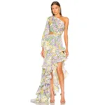 A woman models the Hollowed-Out Hip Irregular Ruffled Floral Dress, featuring a pastel floral one-shoulder design with an asymmetrical hem and waist cutout, styled with strappy nude heels and statement earrings against a white backdrop.