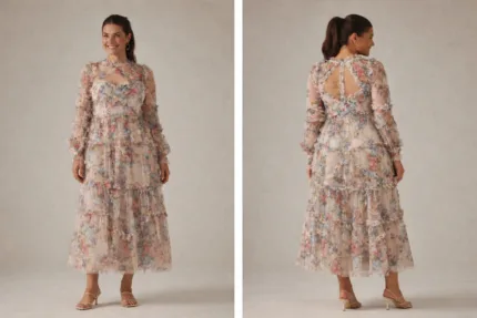 A woman wearing floral translucent patchwork dress with long sleeves, an O-neckline, ankle-length hem, and decorative ruffles, embroidery, and hollow-out details.