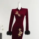 an image of a burgundy long sleeve velvet dress