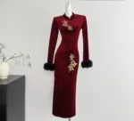 An image of a long sleeved embroidered dress featuring intricate floral patterns, fitted waist maxi dress,