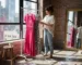 Woman choosing dresses in city loft