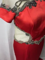 Front view of a red mesh and satin long dress on a mannequin.